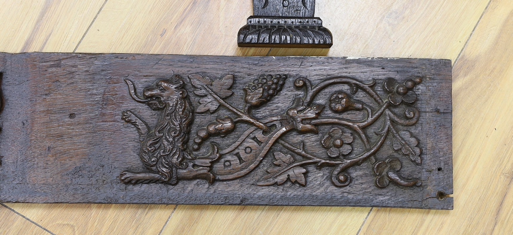 A 17th carved oak figural corbel, a pair of carved oak corbels and a carved oak frieze 14x19cm